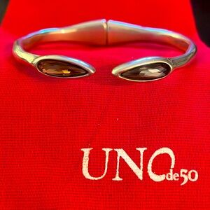UNODE50  hinged silver bracelet with a pink and a grey stone. size M EUC